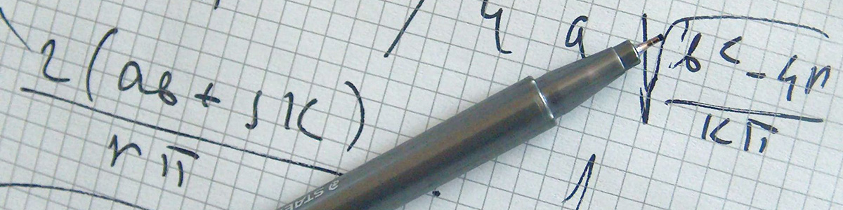 graph paper with mathematical equations and pen