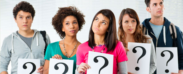 people holding signs with question marks