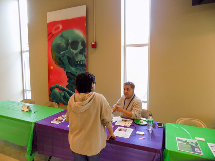 A Columbia Central student speaks with Dr. Mehran Mostajir, Columbia State dean of the Business and Technology Division.