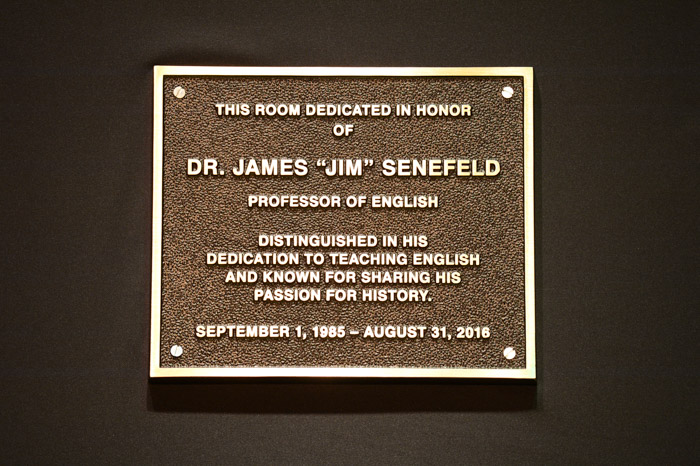 Dr. James Senefeld’s new plaque is placed outside of the Clement 114 classroom.