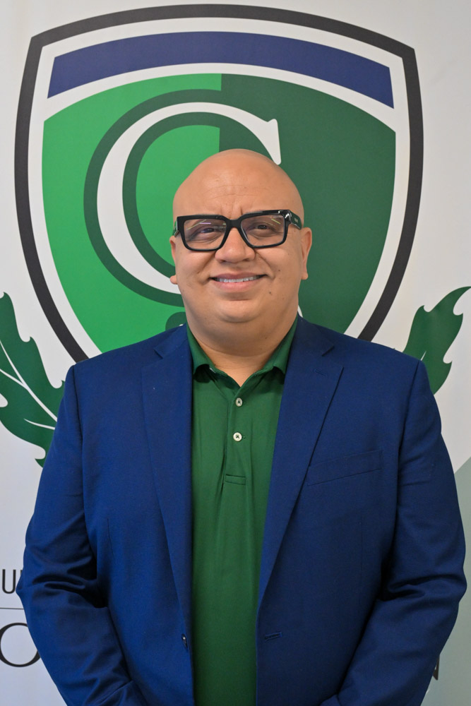 A person poses in front of a white background.