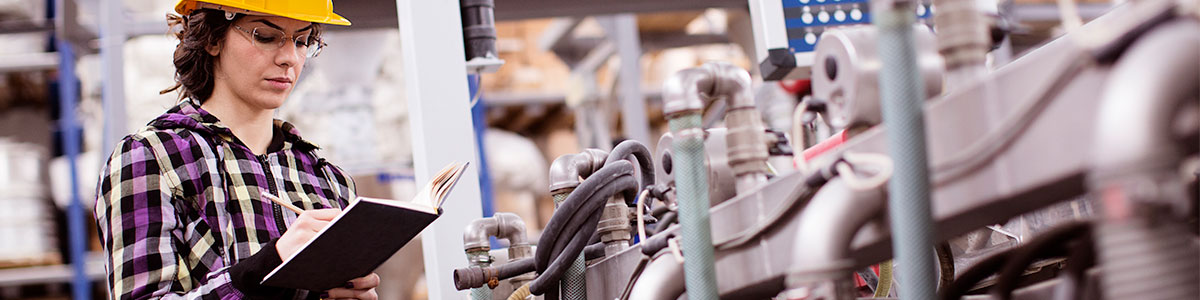 woman checking machinery